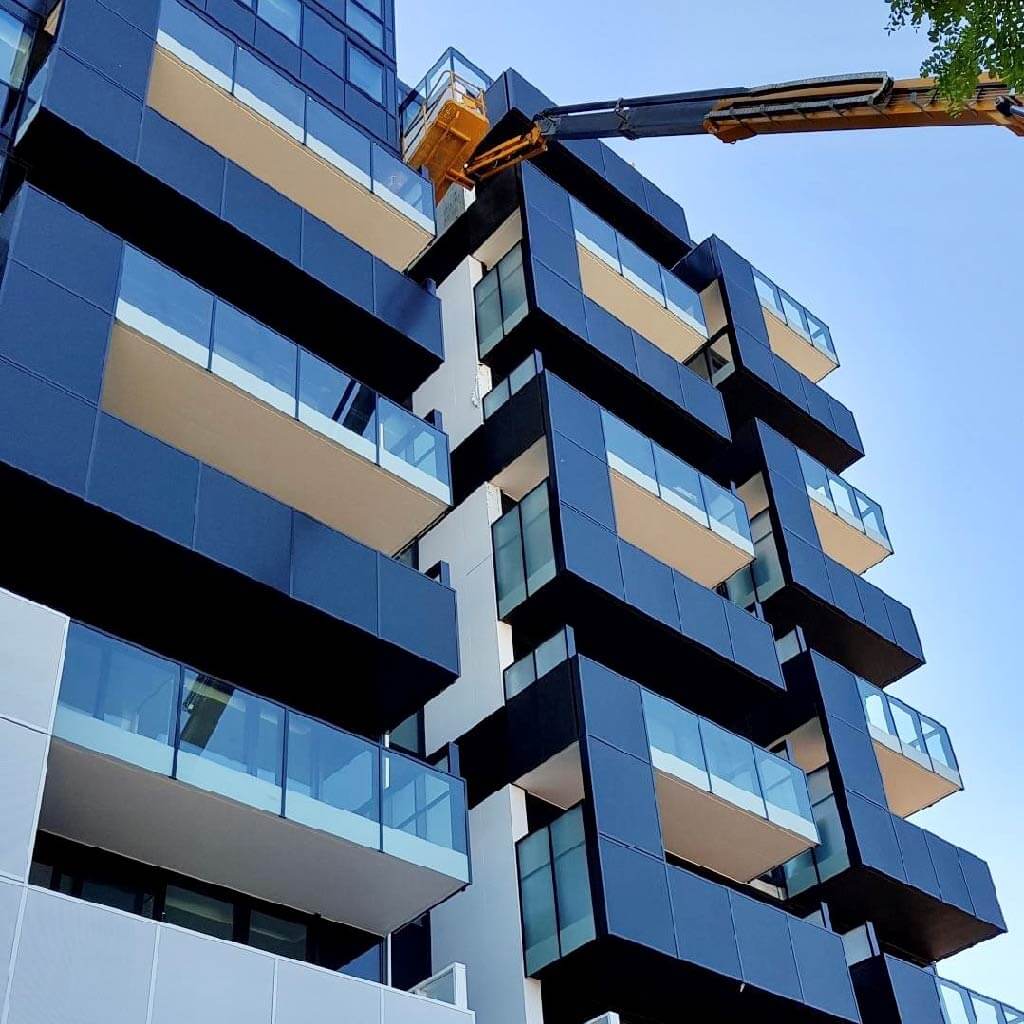 Cherry picker and tall building